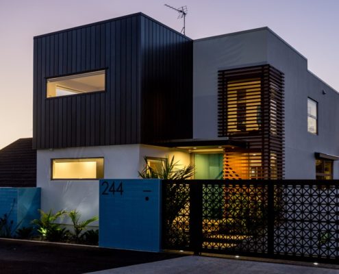 custom-design-incision-decorative-metal-gates custom metal gatesinfrontofahouseatnighttime