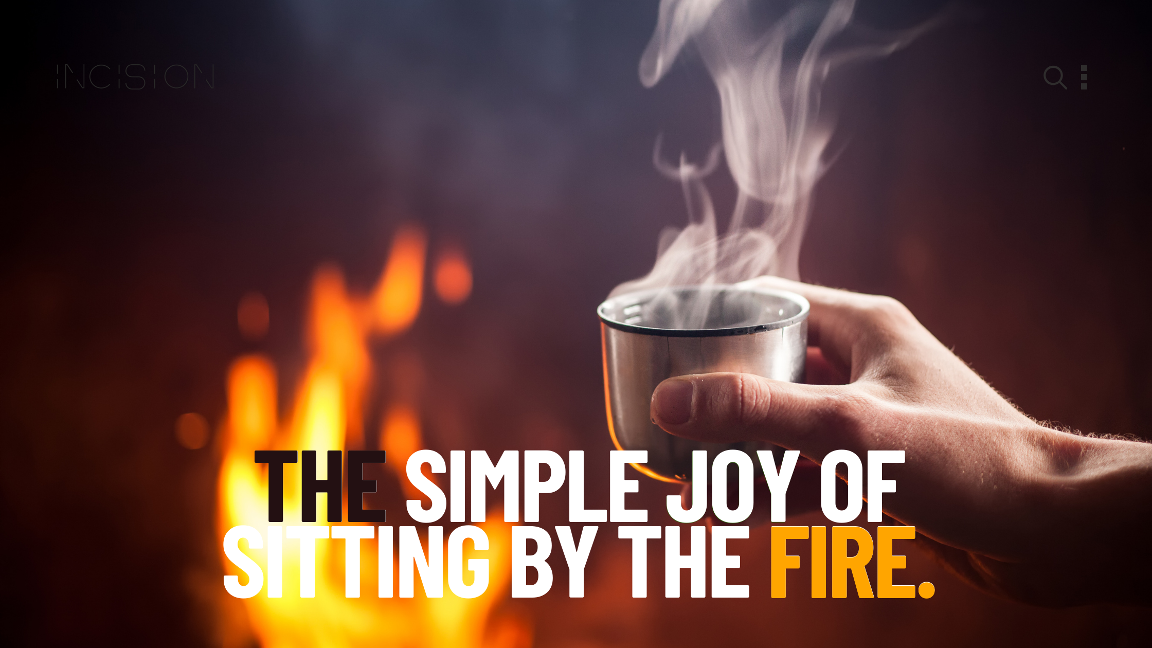 a hand holding a cup of steaming hot chocolate by a fire